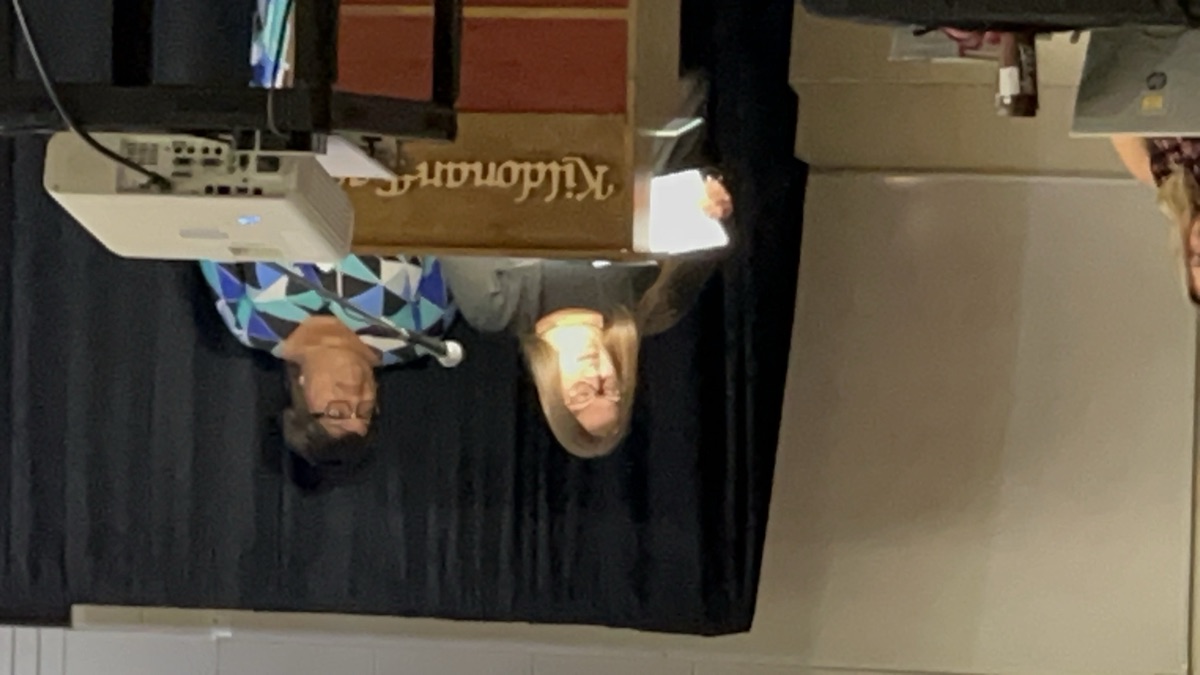 Sheri presenting an award to a student